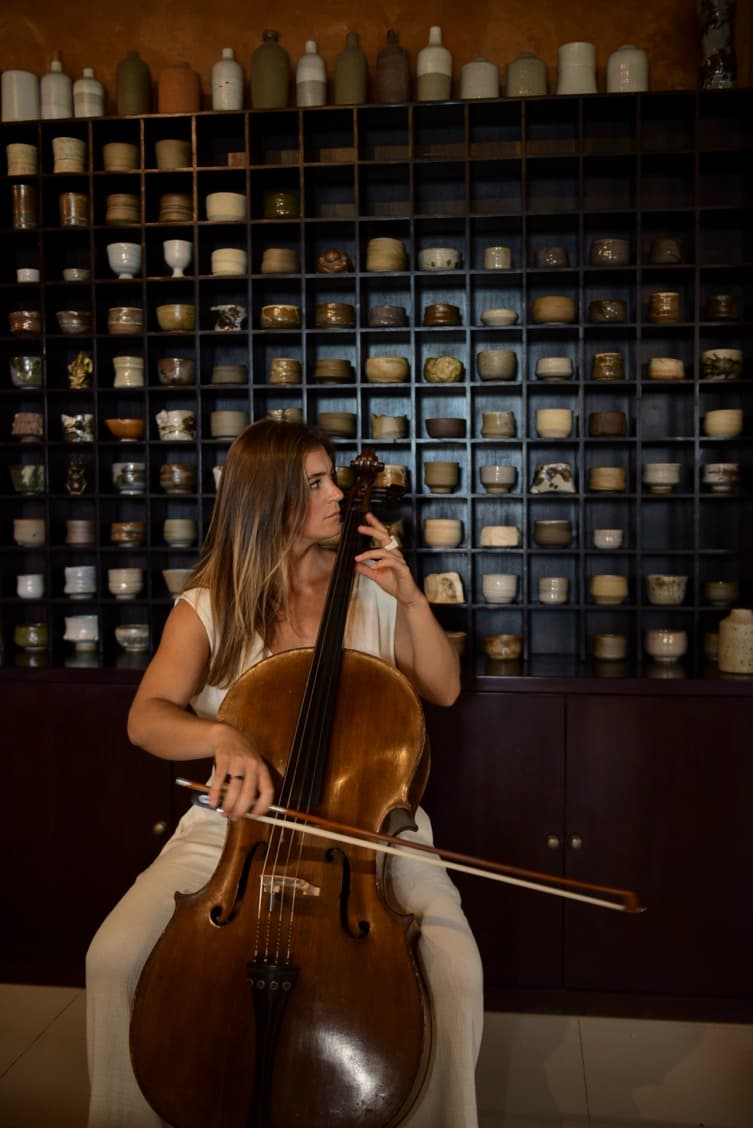 Emily, founder of Musician Gallery, playing cello